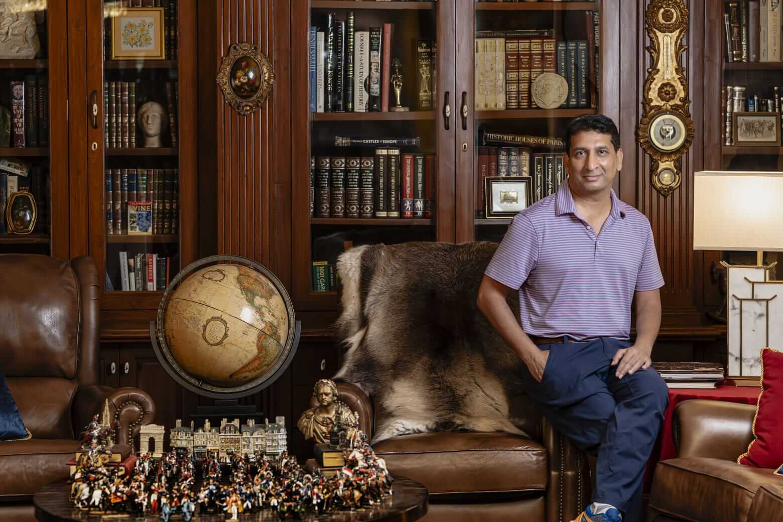 Owner standing proud of his private library collection, a luxurious setting for your wedding venue.